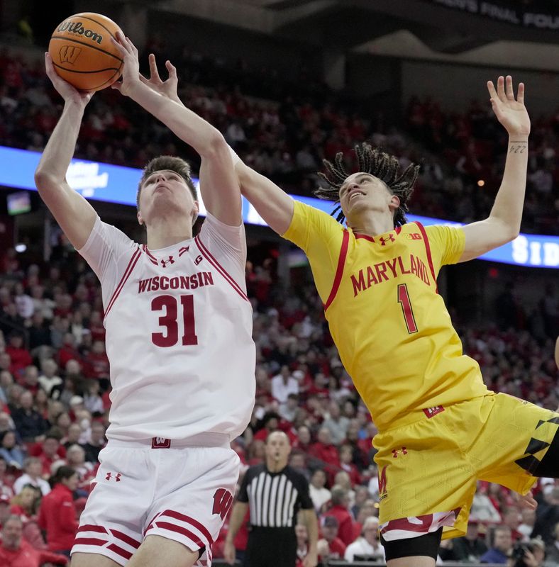 Wisconsin forward Nolan Winter (31) is fouled by Maryland guard Darius Adams (1) during the second half of their game Wednesday, March 4, 2026 at the Kohl Center in Madison, Wisconsin. Wisconsin beat Maryland 78-45.