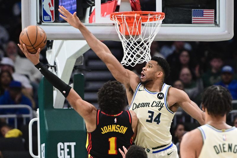 Bucks forward Giannis Antetokounmpo (34) tries to block a shot by Hawks forward Jalen Johnson (1) in the second quarter on Wednesday, March 4 at Fiserv Forum in Milwaukee.
