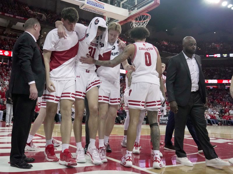 Wisconsin forward Nolan Winter (31) is helped off the court after being injured during the second half of their game Wednesday, March 4, 2026 at the Kohl Center in Madison, Wisconsin. Wisconsin beat Maryland 78-45.