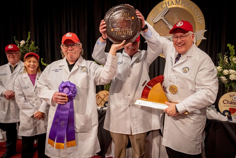 Pictured from left to right with the 2026 World Champion Cheese Beemster Royaal Grand Cru are contest assistant chief judge Josef Hubatschek, assistant chief judge Sandy Toney and Stan Dietsche, chief Judge Jim Mueller and assistant chief judge Tim Czmowski.