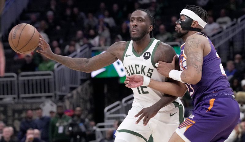 Milwaukee Bucks forward Taurean Prince (12) is guarded by Phoenix Suns guard Jordan Goodwin (23) during the second half of their game Tuesday, March 10, 2026 at Fiserv Forum in Milwaukee, Wisconsin. The Phoenix Suns beat the Milwaukee Bucks 129-114.