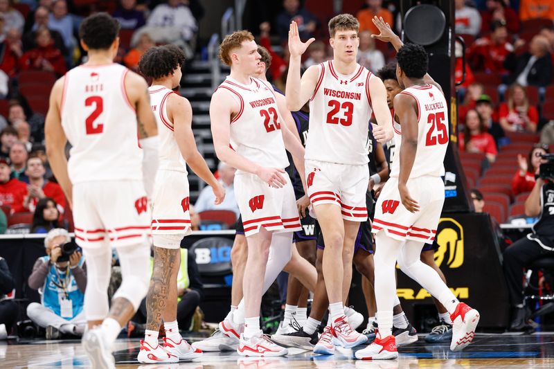Mar 12, 2026; Chicago, IL, USA; Wisconsin Badgers forward Will Garlock (23) celebrates with teammates after scoring against the Washington Huskies during the first half at United Center. Mandatory Credit: Kamil Krzaczynski-Imagn Images
