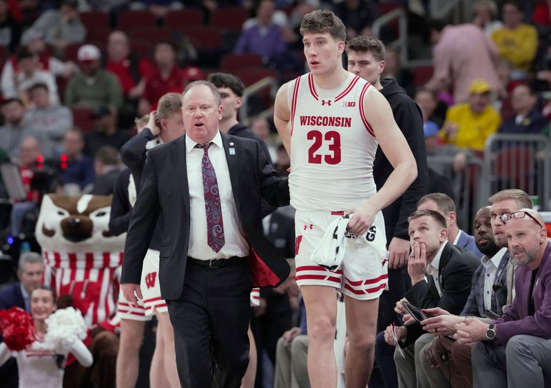 Wisconsin head coach Greg Gard, left, is shown with forward Will Garlock during a game in the Big Ten Tournament on March 12. Gard has said he is in favor of an expansion of the NCAA Tournament.