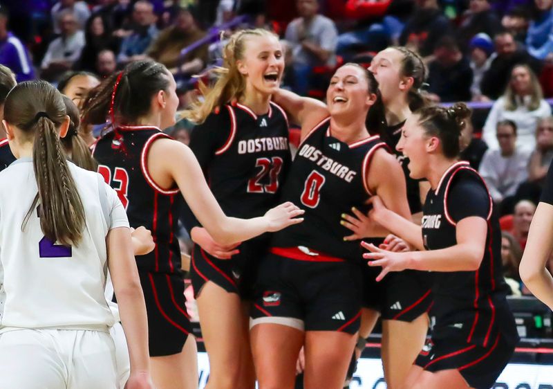 Oostburg players react to winning 63-50 over Mosinee during the WIAA girls state tournament, Thursday, March 12, 2026, in Green Bay, Wis.