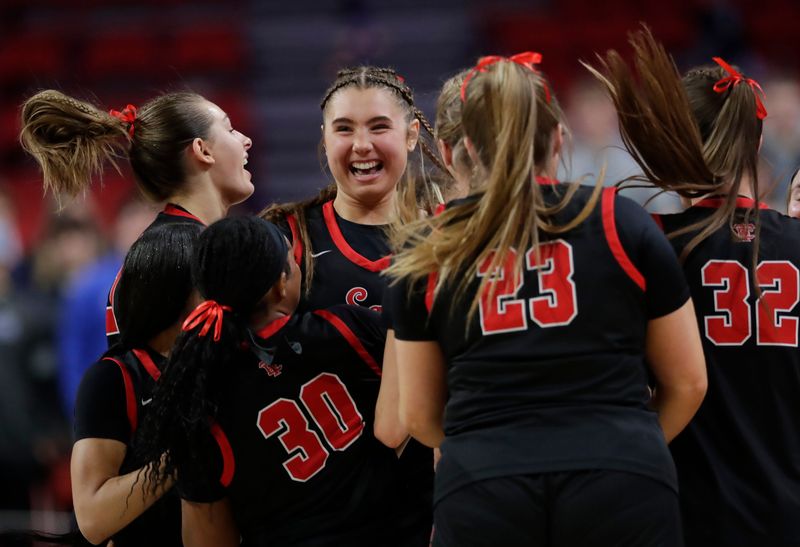 Wauwatosa East High School's players celebrate their victory against Notre Dame High School during their WIAA Division 1 semifinal girls basketball game Friday, March 13, 2026, at the Resch Center in Ashwaubenon, Wisconsin.