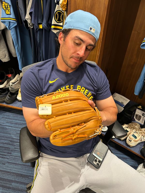 Sal Frelick showcases his glove in the Brewers clubhouse.