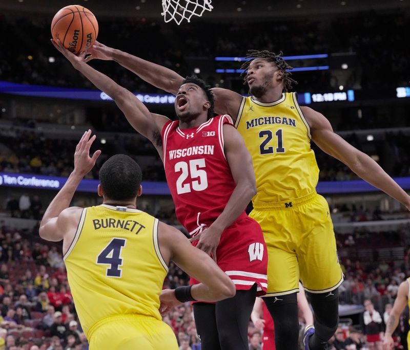 Wisconsin guard John Blackwell tries to score on Michigan guard Nimari Burnett (4) and forward Morez Johnson Jr. (21) during their semifinal game in the Big Ten tournament March 14 at the United Center in Chicago.