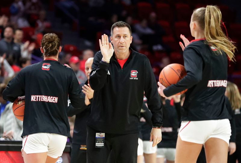 Oostburg coach Isaiah Ketterhagen greets his daugters before at the Div. 3 WIAA championship game with Wisconsin Dells, Saturday, March 14, 2026, in Green Bay, Wis.