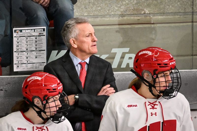 Wisconsin Badgers head coach Mark Johnson and players watch the action in the second period of a WCHA first-round game against the Bemidji State Beavers on Saturday, March 1, 2025, at LaBahn Arena in Madison, Wisconsin. (This caption was updated because an earlier version included an inaccuracy.)
