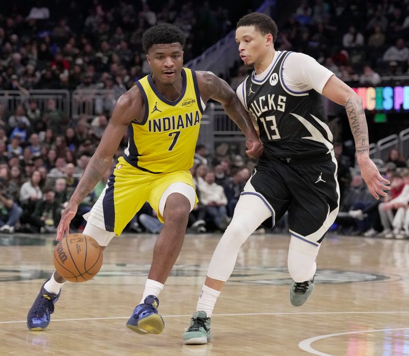Former Marquette standout Indiana Pacers guard Kam Jones (7) drives past Milwaukee Bucks guard Ryan Rollins (13) during the second half of their game Sunday, March 15, 2026 at Fiserv Forum in Milwaukee, Wisconsin. The Milwaukee Bucks beat the Indiana Pacers 134-123.