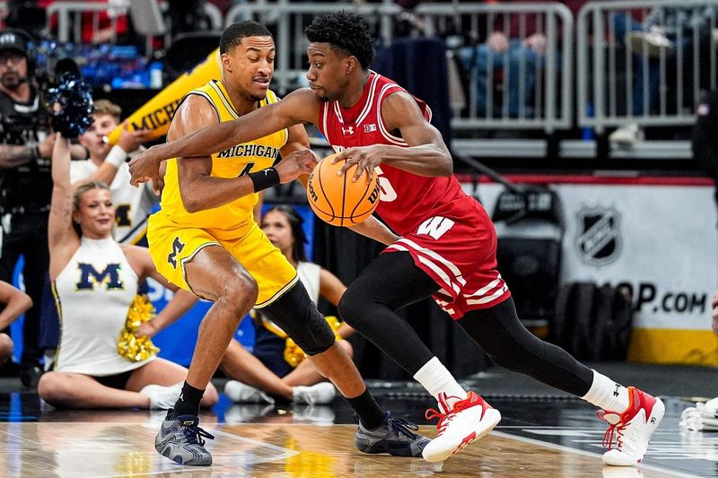 Wisconsin guard John Blackwell (25) dribbles against Michigan guard Nimari Burnett (4) during the first half of Big Ten Tournament semifinal at United Center in Chicago on Saturday, March 14, 2026.