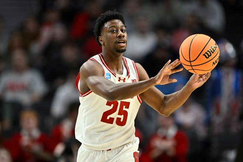 Mar 19, 2026; Portland, OR, USA; Wisconsin Badgers guard John Blackwell (25) passes against the High Point Panthers during the first half of a first round game of the men's 2026 NCAA Tournament at Moda Center.