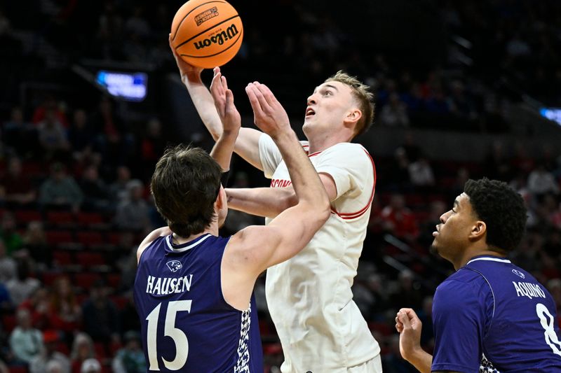 Wisconsin guard Andrew Rohde shoots against High Point forward Braden Hausen during their first-round NCAA Tournament game March 19 at the Moda Center.