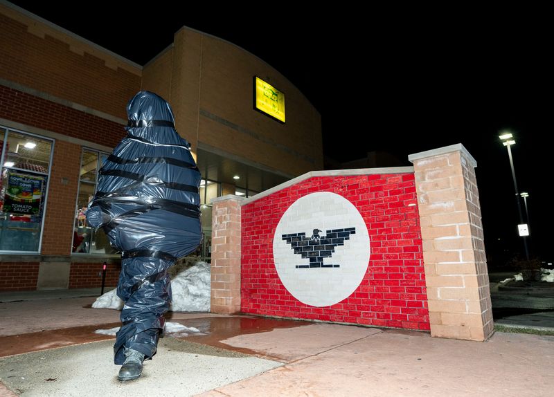 The Cesar Chavez statue along South Cesar Chavez Drive is seen covered with plastic, where it is set to be removed following allegations of sexual abuse against the late labor leader, on Thursday March 19, 2026 in Milwaukee.