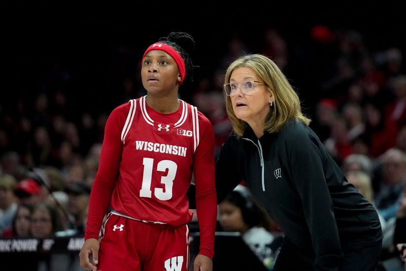 Wisconsin Badgers guard Ronnie Porter (13) speaks with head coach Robin Pingeton in the first half of the NCAA basketball game at Value City Arena on Thursday, Jan. 29, 2026 in Columbus, Ohio.