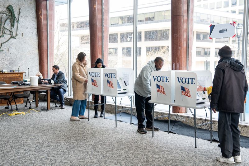 Election officials instruct voters on how to use the machines during early voting at the Frank P. Zeidler Municipal Building on the morning of March 24, 2026 in Milwaukee, Wisconsin. -