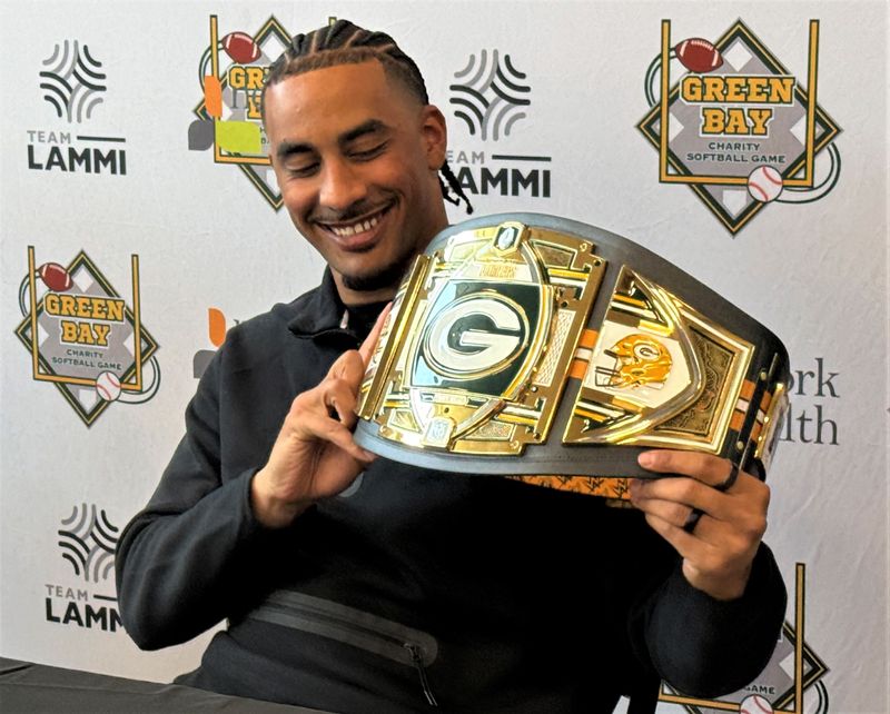 Green Bay Packers quarterback Jordan Love shows off the belt that will go to the winning team in the Green Bay Charity Softball Game on June 5 at Neuroscience Group Field in Grand Chute.
