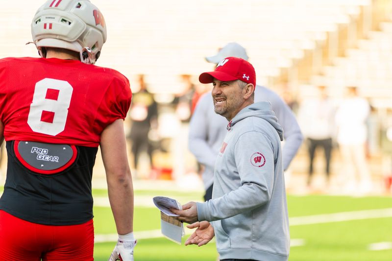 Wisconsin Badgers defensive coordinator Mike Tressel (right) talks with linebacker Mason Posa (left) during a spring practice at Camp Randall Stadium in Madison on March 26, 2026.