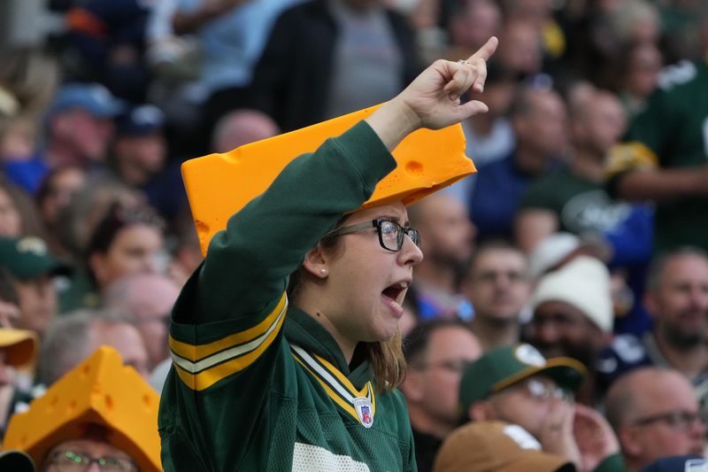 Oct 9, 2022; London, United Kingdom; A Green Bay Packers female fan wearing a Cheesehead reacts during an NFL International Series game against the New York Giants at Tottenham Hotspur Stadium. Mandatory Credit: Kirby Lee-USA TODAY Sports