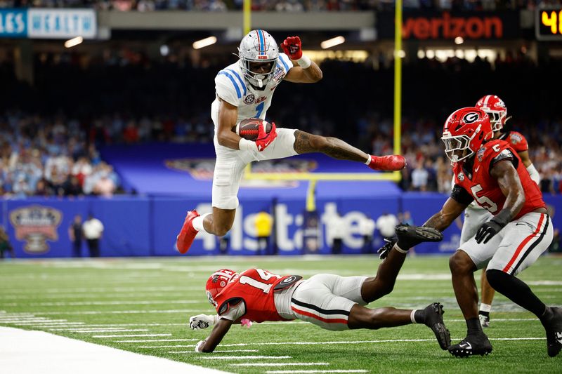 NEW ORLEANS, LOUISIANA - JANUARY 01: De'Zhaun Stribling #1 of the Ole Miss Rebels jumps over Adrian Maddox #14 of the Georgia Bulldogs during the fourth quarter during the 2025 College Football Playoff Quarterfinal at the Allstate Sugar Bowl at Caesars Superdome on January 01, 2026 in New Orleans, Louisiana. (Photo by Sean Gardner/Getty Images)