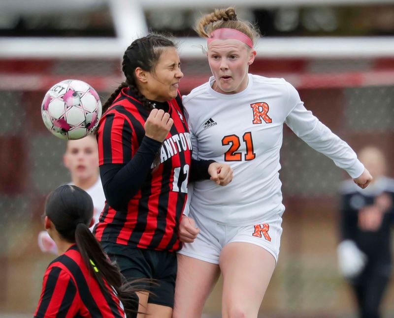 Cedar Grove-Belgium’s Gracie Schmidt (21) watches the ball by Manitowoc Lincoln’s Ava Quinchia (12) at Ron Rubick Field, Tuesday, March 31, 2026, in Manitowoc, Wis.