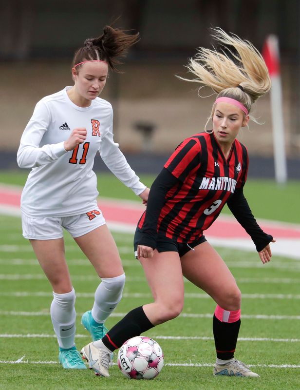 Manitowoc Lincoln’s Sarah Bolchen (3) looks to kick the ball by Cedar Grove-Belgium’s Arden Getschman (11) at Ron Rubick Field, Tuesday, March 31, 2026, in Manitowoc, Wis.