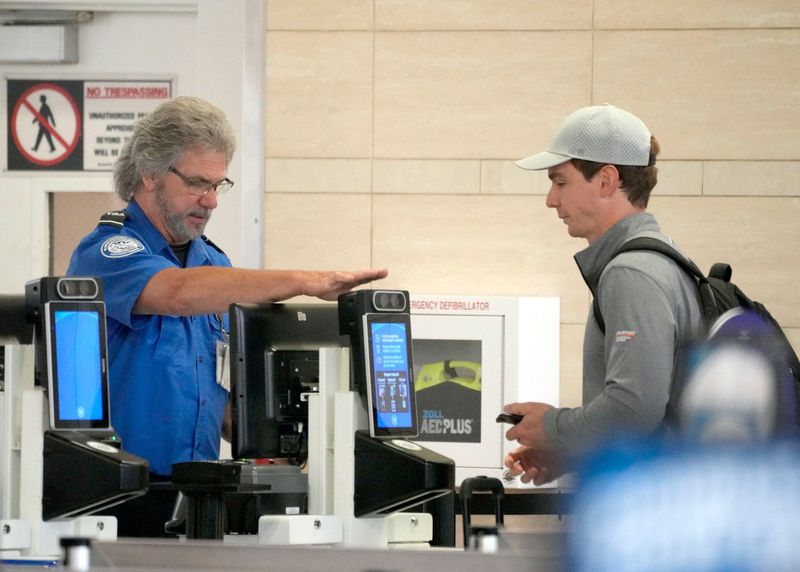 A passenger makes their way through TSA security screening at Milwaukee Mitchell International Airport in Milwaukee on Wednesday, May 7, 2025. TSA Precheck travelers are now able to use a Touchless ID option to speed their way through security. - Mike De Sisti / Milwaukee Journal Sentinel