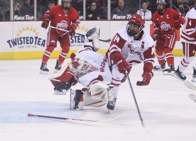 Wisconsin's Joe Palodichuk (14) collides with Badgers goaltender Daniel Hauser as Hauser attempts to make a save in the second period Wednesday March 11, 2026 at the Kohl Center in Madison, Wis. Ohio State scored on the play to take a 3-0 lead.