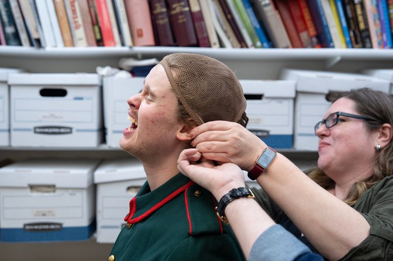 Dana Rochester and Jason Orlenko (not pictured) adjust a wig cap before fitting freshman Thomas Füglsang with a wig for the upcoming production of “Three Sisters” at the Peck School of the Arts at the University of Wisconsin-Milwaukee on the afternoon of April 1.