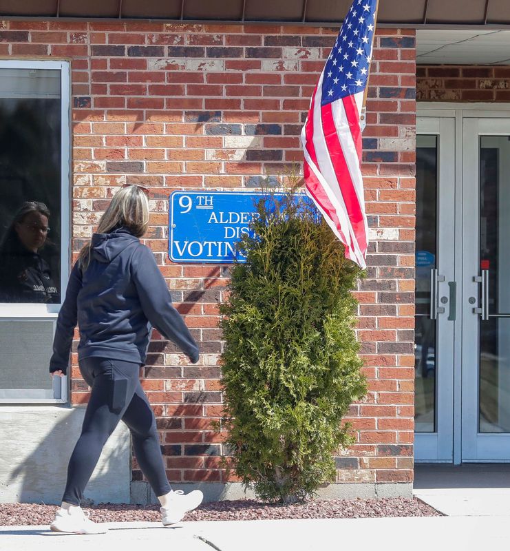 A woman walks to the Manitowoc Senior Center entrance, which is also a polling place Tuesday, April 7, 2026.