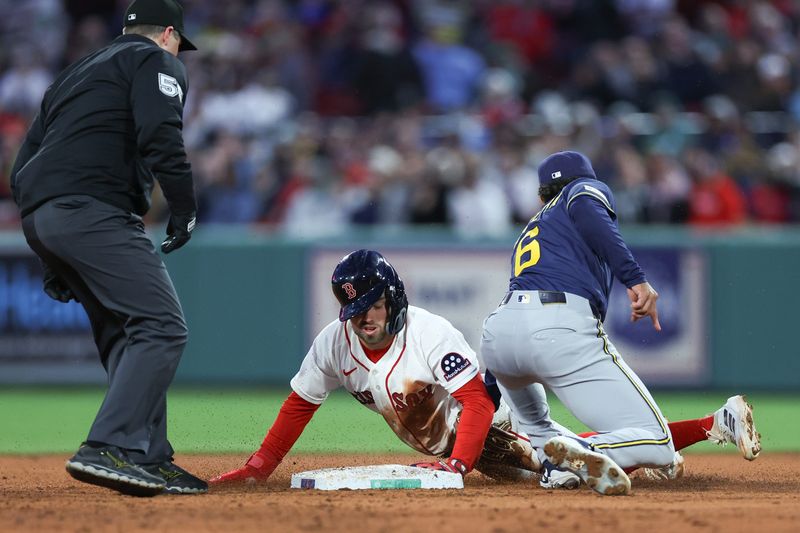 Apr 6, 2026; Boston, Massachusetts, USA; Milwaukee Brewers shortstop David Hamilton (6) tags out Boston Red Sox third baseman Caleb Durbin (5) during the second inning at Fenway Park. Mandatory Credit: Paul Rutherford-Imagn Images