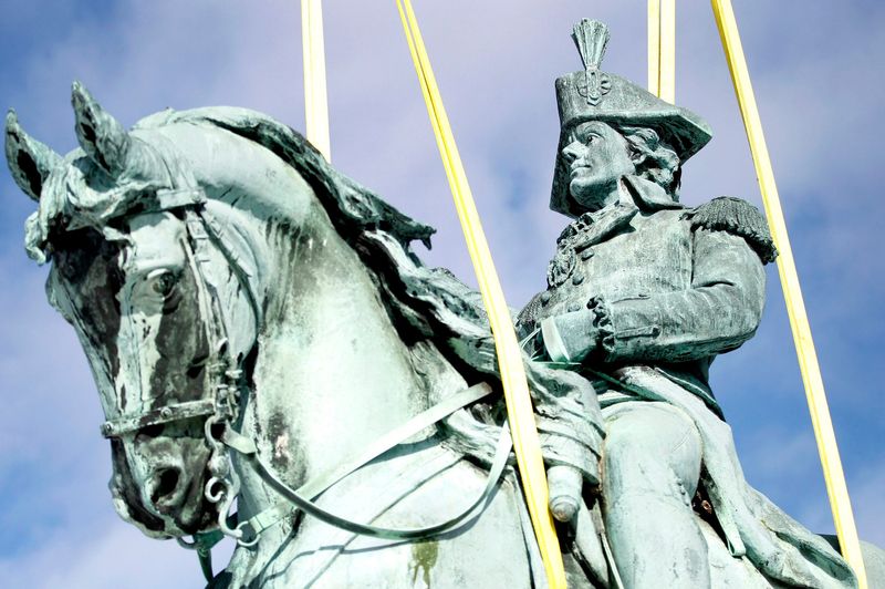 A bronze statue of Revolutionary War hero Gen. Tadeusz Kosciuszko weighing 8,200 pounds is lifted with a crane to a flatbed truck on Feb. 12, 2013 at Kosciuszko Park. The statue was presented to the City of Milwaukee in 1905 by the Polish community.