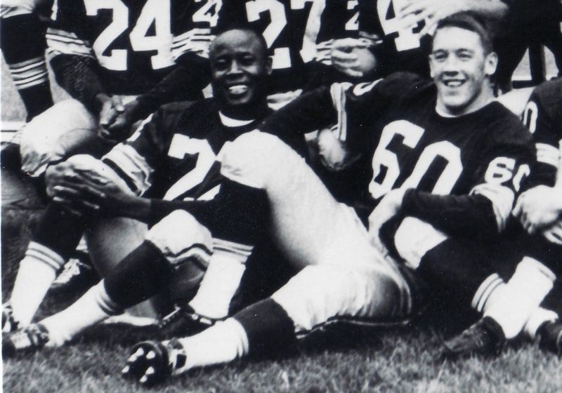 Ed Blaine, No. 60, sits next to Elijah Pitts during a Green Packers team photo session before the 1962 season.