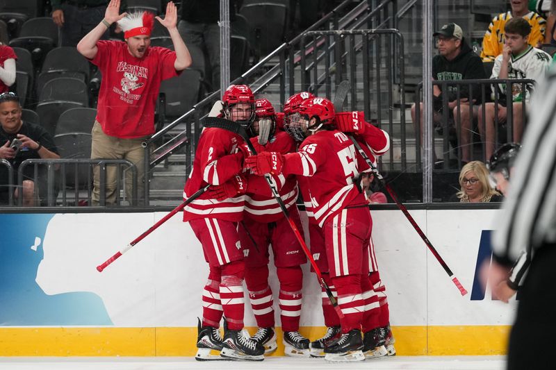 Apr 9, 2026; Las Vegas, Nevada, UNITED STATES; Wisconsin Badgers forward Ryan Botterill (21) celebrates a goal with teammates in the first period against the North Dakota Fighting Hawks in the semifinals of the NCAA men's ice hockey Frozen Four at T-Mobile Arena. Mandatory Credit: Lucas Peltier-Imagn Images