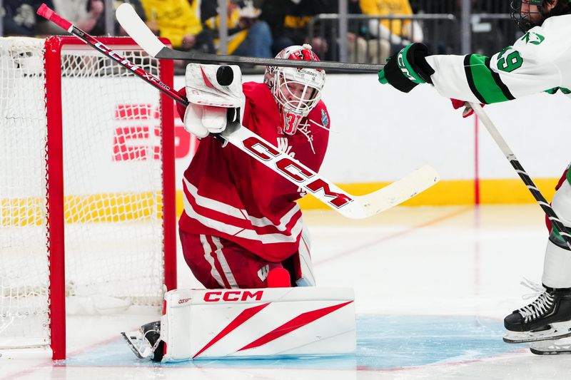 Apr 9, 2026; Las Vegas, Nevada, UNITED STATES; Wisconsin Badgers goalie Daniel Hauser (31) blocks a shot on goal in the third period against the North Dakota Fighting Hawks in the semifinals of the NCAA men's ice hockey Frozen Four at T-Mobile Arena. Mandatory Credit: Stephen R. Sylvanie-Imagn Images