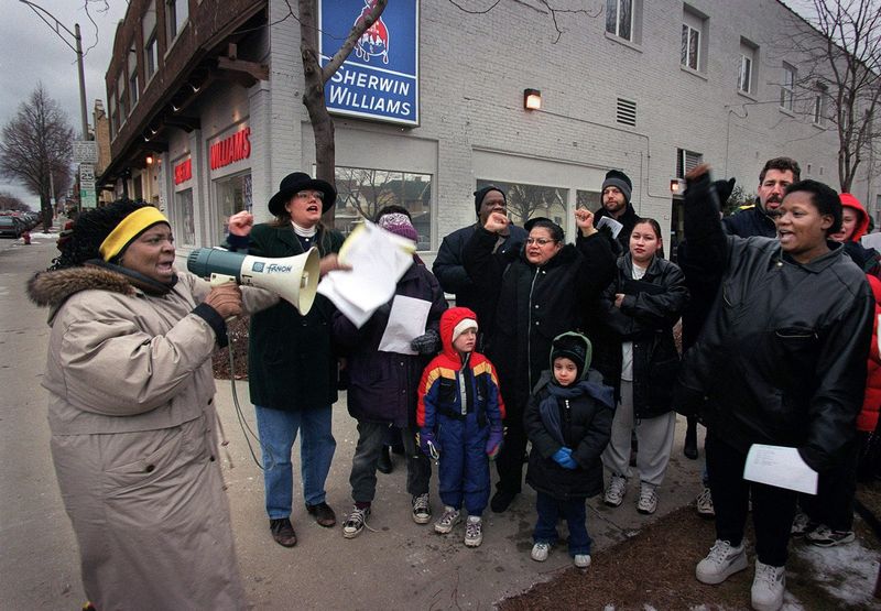 In this file photo from Jan. 17, 2000, about a dozen parents, teachers and community activists from Wisconsin Citizen Action public interest organization protest outside the Sherwin Williams paint store, 3510 N. Oakland Ave. They were calling for the Milwaukee Common Council to sue paint manufacturers for the use of lead-based paint many years ago.