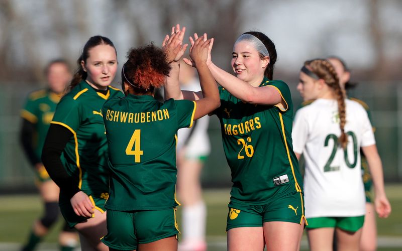 Ashwaubenon High School's Adelynn Milquet (26) celebrates after teammate Malaiya Moore (4) scored a goal during a soccer match against Freedom High School on April 10, 2026, in Ashwaubenon, Wis.