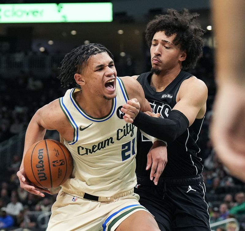 Milwaukee Bucks forward Ousmane Dieng (21) posts up against Brooklyn Nets forward Jalen Wilson (22) during the second half of their game on Friday April 10, 2026 at Fiserv Forum in Milwaukee, Wisconsin.