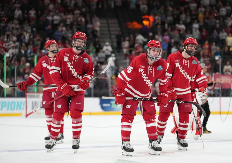 Apr 11, 2026; Las Vegas, Nevada, United States; Wisconsin Badgers defenseman Luke Osburn (2) and defenseman Weston Knox (26) react after losing to the Denver Pioneers in the championship game of the NCAA men's ice hockey Frozen Four at T-Mobile Arena. Mandatory Credit: Lucas Peltier-Imagn Images