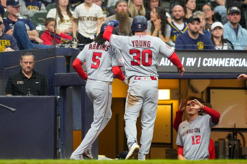 Nationals center fielder Jacob Young (30) celebrates with shortstop CJ Abrams (5) after they both scored during the eighth inning to put Washington ahead to stay against the Brewers on Sunday, April 12 at American Family Field.