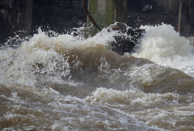 Water rushes past a concrete pillar in the Fox River on April 14 in Appleton. Thunderstorms and heavy overnight rain caused high water, closed roads and flood warnings in the Fox Cities.