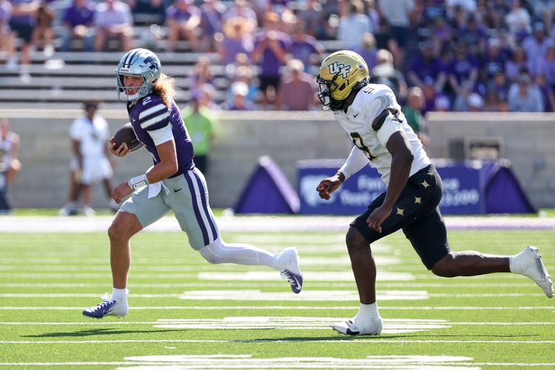 Sep 27, 2025; Manhattan, Kansas, USA; Kansas State Wildcats quarterback Avery Johnson (2) runs from UCF Knights defensive end Nyjalik Kelly (9) during the fourth quarter at Bill Snyder Family Football Stadium. Mandatory Credit: Scott Sewell-Imagn Images