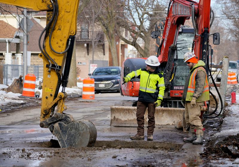Chris Williams, left, and Eddie Christoffel, Milwaukee Water Works foreman, are seen in the 2000 block of North 49th Street in Milwaukee on Feb. 12, 2026, where lead pipes are being replaced with copper pipes.