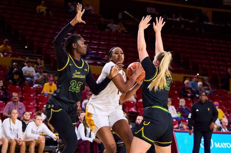 Arizona State Sun Devils forward Kadidia Toure (1) jumps to shoot as San Francisco Dons forward Seynabou Thiam (25) and guard Cami Fulcher (32) move to block at Desert Financial Arena in Tempe on Nov. 13, 2023.