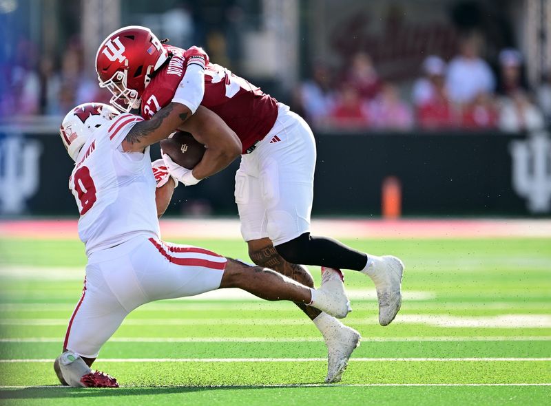 Nov 15, 2025; Bloomington, Indiana, USA; Indiana Hoosiers tight end Riley Nowakowski (37) is tackled by Wisconsin Badgers safety Austin Brown (9) during the second half at Memorial Stadium. Mandatory Credit: Marc Lebryk-Imagn Images