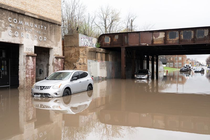 Vehicles remain stranded beneath a bridge near Community Within the Corridor on West Center Street on April 16, 2026, in Milwaukee, Wisconsin. - Angelica Edwards / The Milwaukee Journal Sentinel