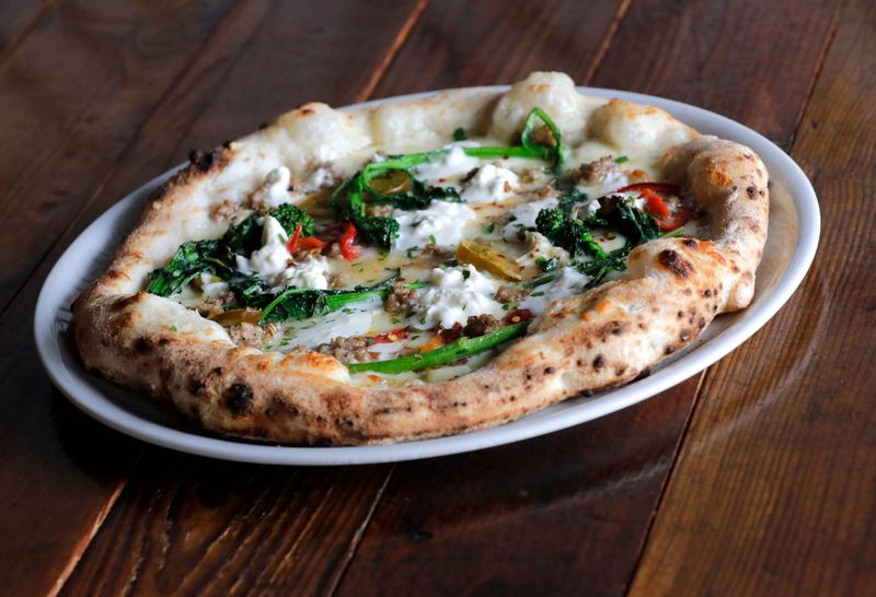 Peppe pizza is available at VIA Pizza Napoletana located at 716 N. Casaloma Drive Thursday, April 15, 2026, in Grand Chute, Wisconsin. The pizza consists of fior di latte, crumbled sausage, broccoli rabe, cherry pepper, stracciatella, garlic, hot chile and extra virgin olive oil.