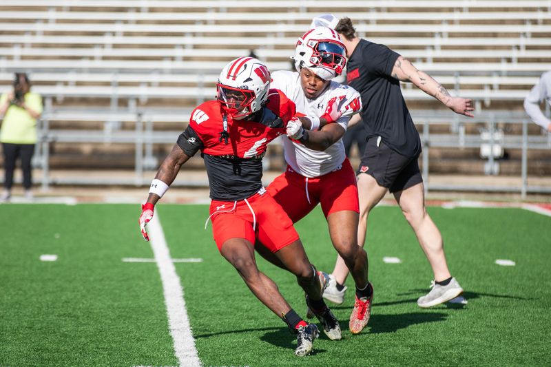 Wisconsin cornerback Eric Fletcher (left) competes against running back Bryan Jackson during a spring practice at Camp Randall Stadium on April 16.
