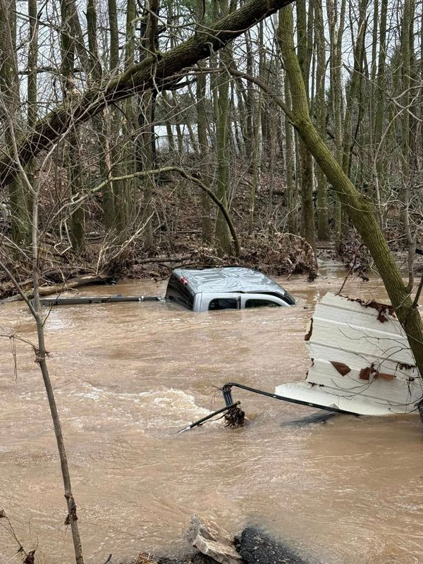 A truck belonging to Robert Morrow of Abrams rests in the Little Suamico River after he unknowingly drove across a washed-out bridge on Jaworski Road in the Town of Chase on April 14, 2026.