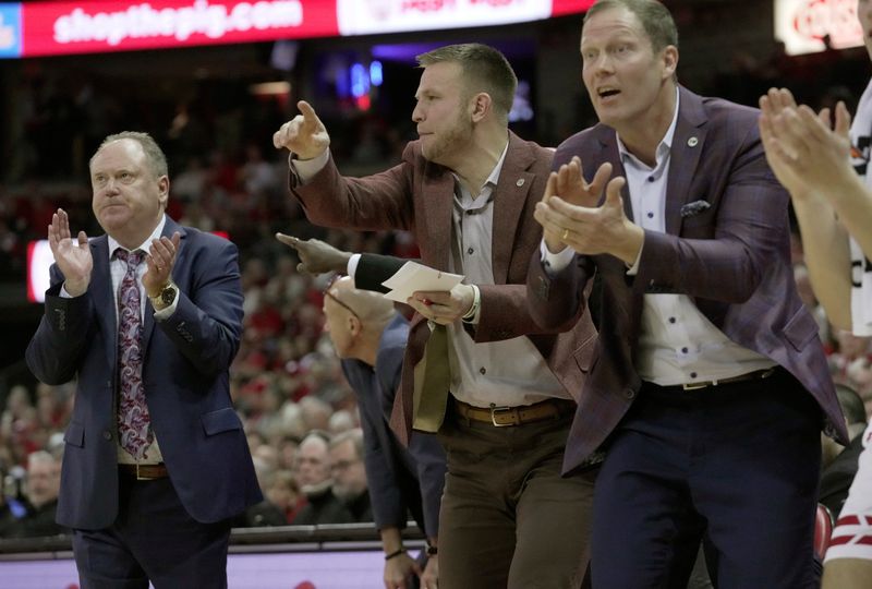 Wisconsin special assistant to the head coach Brad Davison, center is shown during the first half of their game against UCLA Tuesday, January 6, 2026 at the Kohl Center in Madison, Wisconsin. At left is head coach Greg Gard.